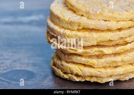 macro of corn wafers on a brown wooden surface with copy space Stock Photo