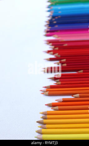 Colored Pencils in a Rainbow Sprectrum against a White Background Stock Photo