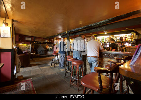 English village pub interior with customers at the bar Stock Photo