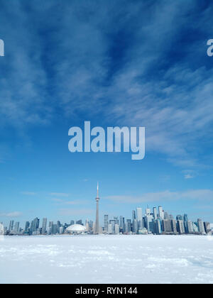 Toronto city skyline seen from toronto Islands over frozen lake Ontario Stock Photo