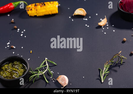red hot chili pepper corns and corn on black culinary background, top view. Space for text Stock Photo