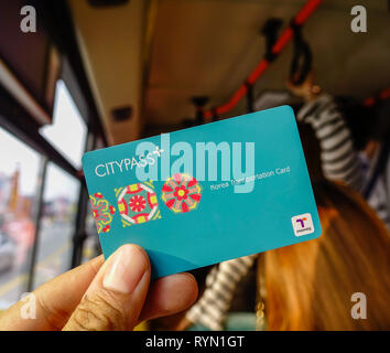 Seoul, South Korea - Feb 6, 2015. Passenger showing CityPass Card on Seoul public bus. The card can be use many public transport in South Korea. Stock Photo