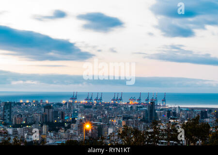 This is a capture of the sunset in Beirut capital of Lebanon with a warm orange color and cool tone cloud and you can see Beirut port in the picture. Stock Photo