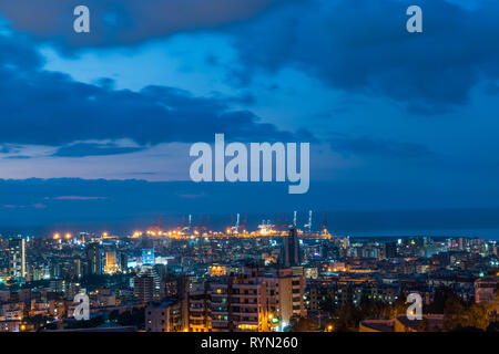 This is a capture of the sunset in Beirut capital of Lebanon with a warm orange color and cool tone cloud and you can see Beirut port in the picture. Stock Photo