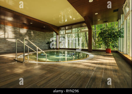 Big round jacuzzi bath in spa center, early morning Stock Photo