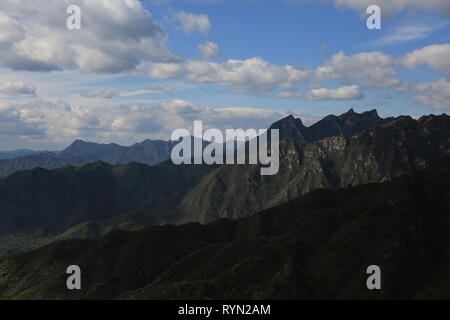 The Great Wall surrounding mountains at Mutianyu, Beijing, China Stock Photo