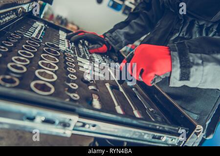 Car Mechanic Choosing Right Tools For the Job. Car Repair Concept. Stock Photo