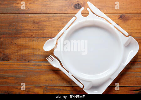 Plastic Plate on Wooden Background Stock Photo