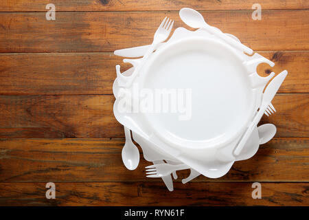 Plastic Plates on Wooden Background Stock Photo
