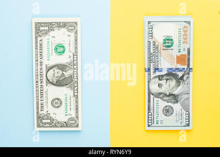 Commercial money investment profit concept. 1 us dollar and 100 dollars. Heap of one dollars banknote and hundred us dollar bills on blue and yellow b Stock Photo