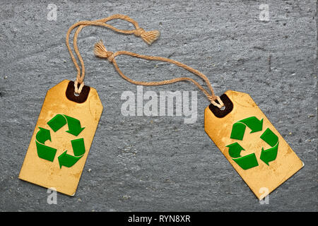 Two natural label tags and recycling symbol on Black textured granite slate Stock Photo
