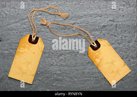 Two natural label tags on Black textured granite slate Stock Photo