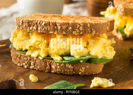 Hearty Homemade Egg Breakfast Sandwich with Lettuce and Cheese Stock Photo