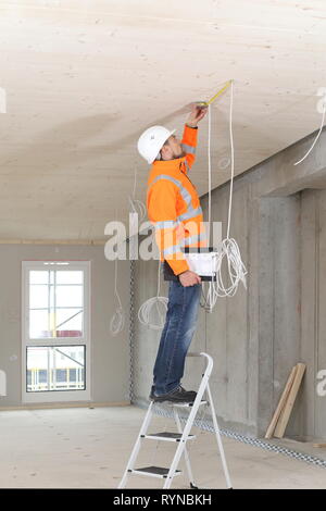 A Construction expert appraiser checking a new construction Stock Photo