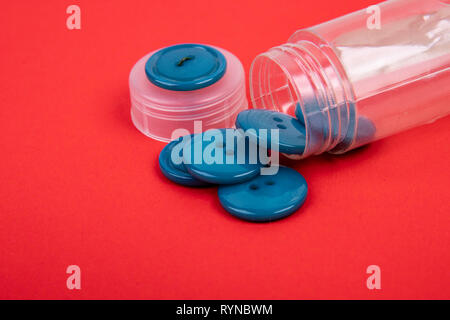 blue buttons from a button box on a red background Stock Photo