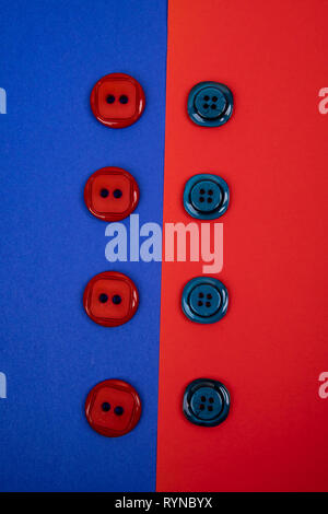blue buttons on red background and red buttons on blue background separated in the middle Stock Photo