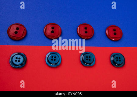 blue buttons on red background and red buttons on blue background separated in the middle Stock Photo