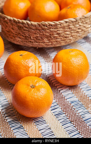 tangerine basket with artisan tablecloth background Stock Photo - Alamy