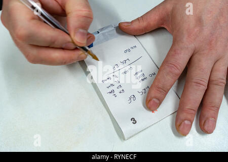 Close up photograph of a waiter's hands writing on order pad and taking customers Breakfast Order in a cafe