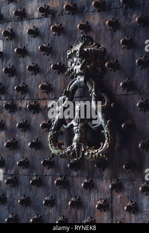 Black metallic Italian style door handle and knocker Stock Photo