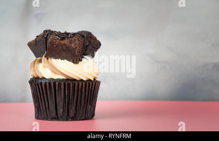 Brownie Cupcake on pink table with gray copy space Stock Photo