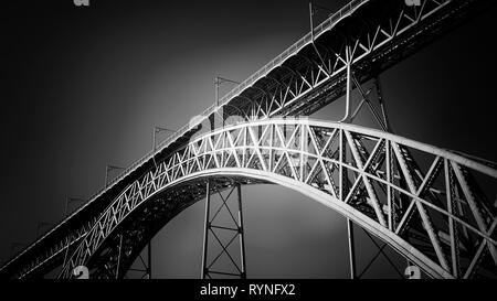 One of the old iron bridges over Douro river, D. Luis bridge, Porto. Used infrared filter. Stock Photo