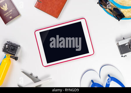Blank tablet screen surrounded by summer beach travel accessories Stock Photo