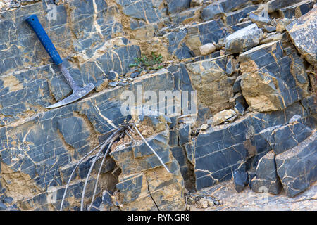 Geological hammer on the rocks Stock Photo