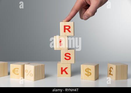 Hand hold wooden cubes with risk word. Risk management concept. Stock Photo