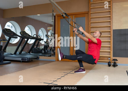 Man exercising with suspension training trx. Total body resistance exercises Stock Photo