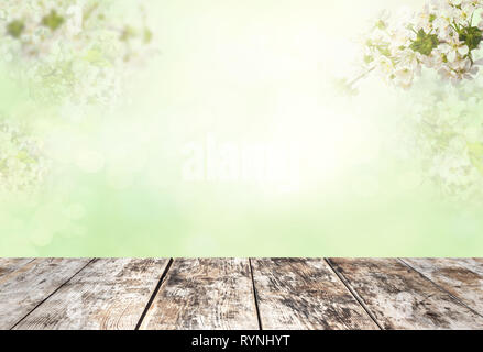 Wood table top on blur white green natural abstract background from tree branches Stock Photo