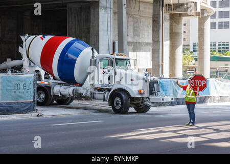 Miami Florida,downtown,concrete mixer,cement truck,under new construction site building builder,building,worker,workers,stop sign,direct traffic,FL090