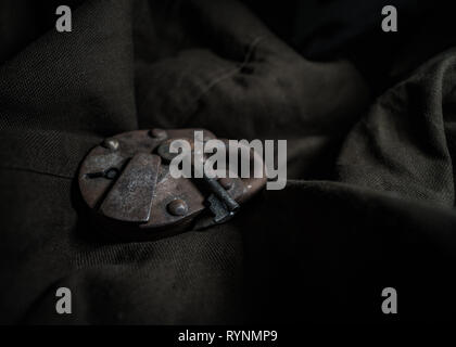 Old Rusted Skeleton Padlock displayed on a textured drop. Stock Photo