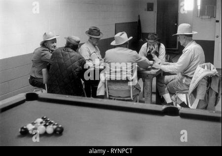 Pool hall 1970s USA. Group of old men playing dominoes talking passing the time of day concentration wearing cowboy hats candid reportage interior scene. Astec New Mexico US 70S HOMER SYKES Stock Photo