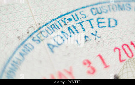 KYIV, UKRAINE - FEBRUARY 2019: close up macro of United States of America immigration customs stamp with the word Admitted in focus Stock Photo