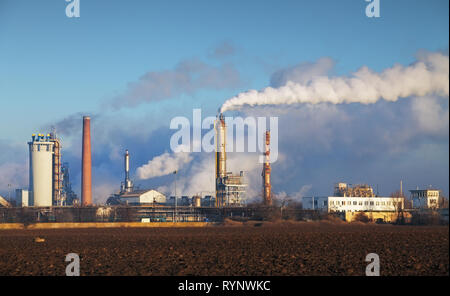 Oil refinery with vapor - petrochemical industry. Stock Photo