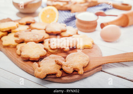 Happy Easter. Baking Easter bunnies. Ingredients with Easter decoration on wooden table Stock Photo