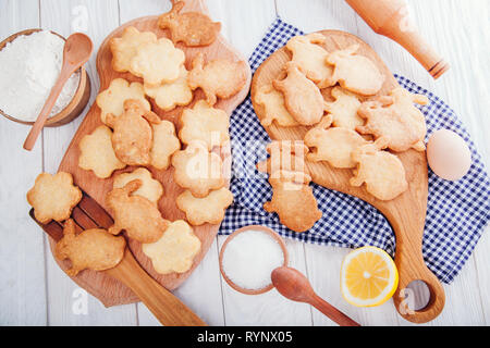 Happy Easter. Baking Easter bunnies. Ingredients with Easter decoration on wooden table Stock Photo