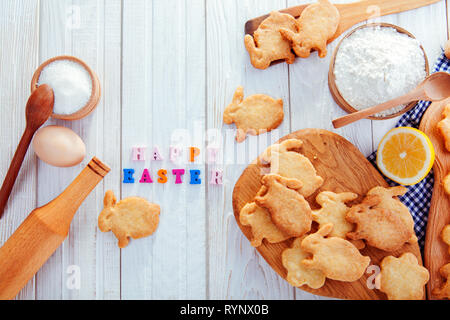 Happy Easter greeting. Baking Easter bunnies. Cookies with ingredients Stock Photo
