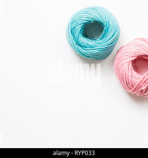 Pink and green string roll thread reel isolated on white background Stock Photo