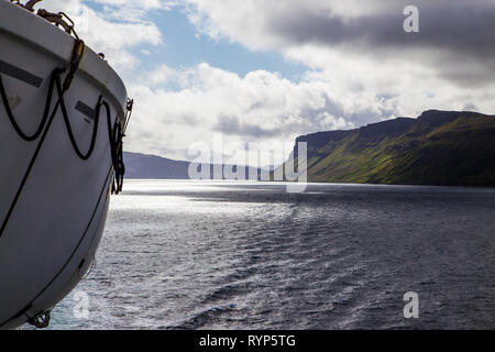 Lifeboat on ship with stunning view in background. Stock Photo