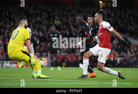 Arsenal's Pierre-Emerick Aubameyang (right) shoots during the Europa League match at the Emirates Stadium, London. Stock Photo