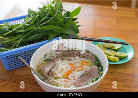 Soup pho with beef in a budget restaurant in Ho Chi Minh City, Vietnam for 45 000 dongs (2 US dollars). Stock Photo