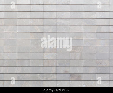 Full frame background of a new, modern and clean stone wall or building exterior. Stock Photo