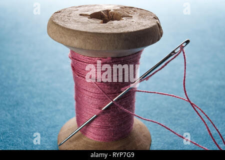 Cotton Reel with Sewing Needle Stock Photo - Alamy