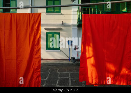 Monks' robes hung out to dry at monks dwellings in the grounds of Wat Benchamabophit (often called Marble Temple), Bangkok, Thailand Stock Photo