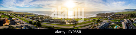 4K Aerial at shoreline of the Pacific ocean coast on a sunset, San Simeon, central California Stock Photo