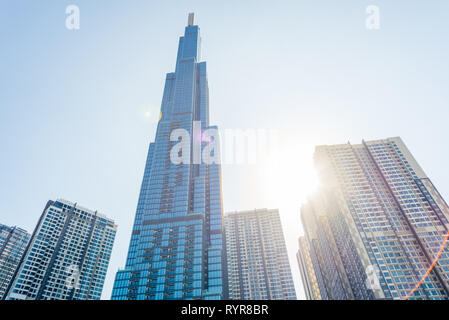 Ho Chi Minh City, Vietnam - February 19, 2019: Landmark 81 against the blue sky with sun shining and lens flares.