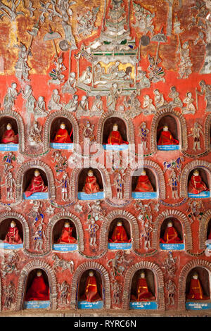 Religious offerings in a wall at Shwe Yan Pyay monastery, Myanamar Stock Photo