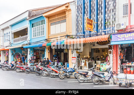 Phuket, Thailand - 11th April 2017: Motorcycles parked outside shops on Thalang Road. This is one of the main streets in the old town. Stock Photo